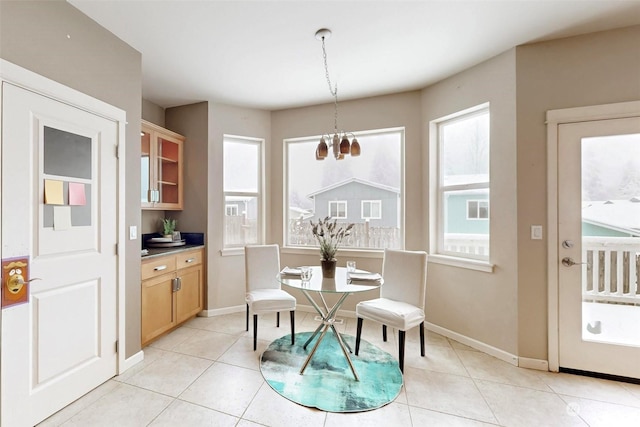 dining room with light tile patterned floors and a chandelier