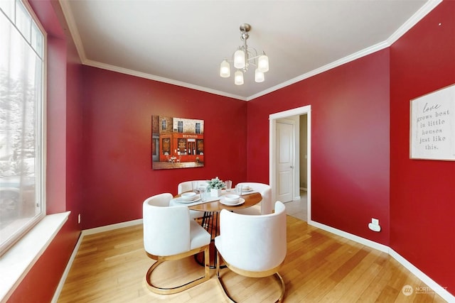 dining space featuring an inviting chandelier, hardwood / wood-style floors, and plenty of natural light