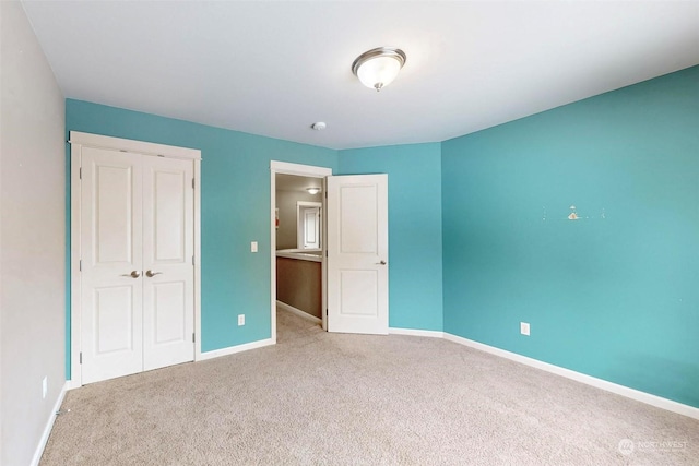 unfurnished bedroom featuring carpet floors and a closet