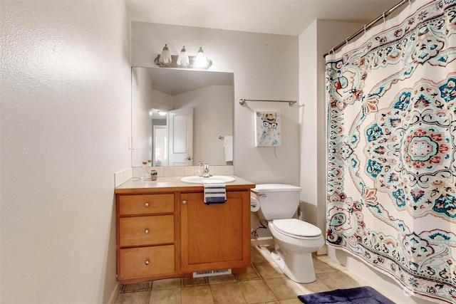 bathroom with vanity, toilet, and tile patterned flooring