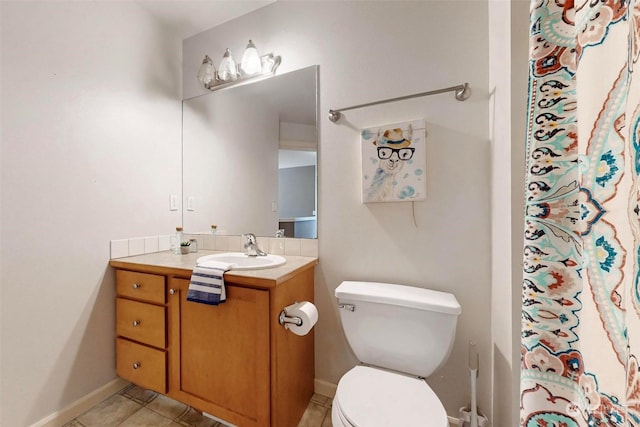 bathroom with tile patterned floors, toilet, and vanity