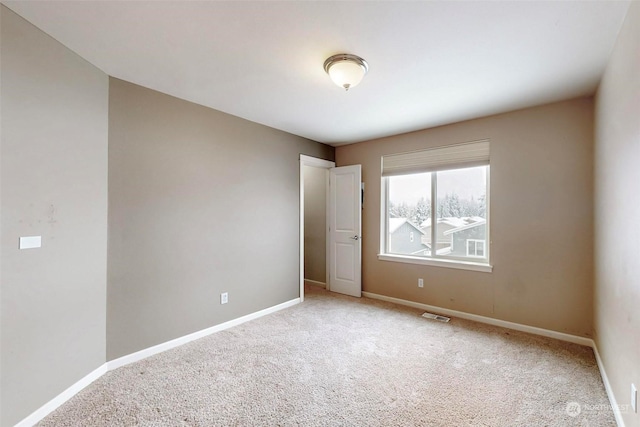 empty room featuring light carpet