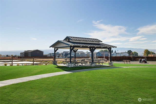 surrounding community with a gazebo and a yard