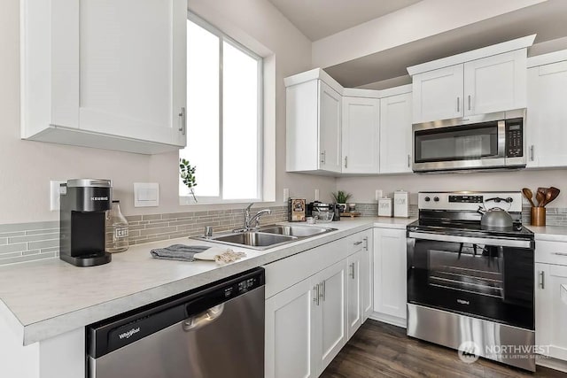 kitchen featuring white cabinets, plenty of natural light, sink, and appliances with stainless steel finishes