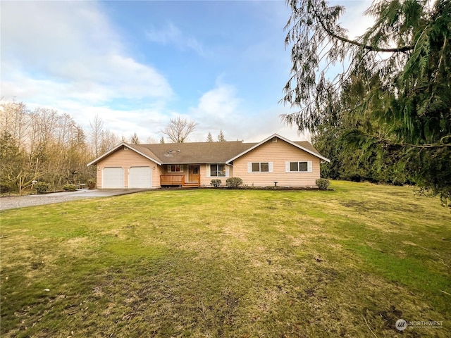 single story home featuring a garage and a front lawn