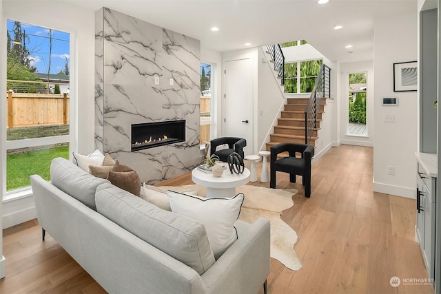 living room with light hardwood / wood-style flooring and a fireplace