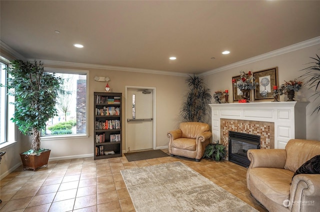 sitting room with a brick fireplace, light tile patterned flooring, and ornamental molding