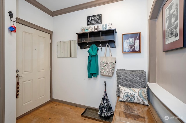 mudroom with light hardwood / wood-style floors and crown molding