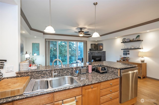 kitchen with dishwasher, light wood-type flooring, crown molding, pendant lighting, and sink