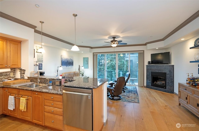 kitchen with light wood-type flooring, dishwasher, pendant lighting, and kitchen peninsula