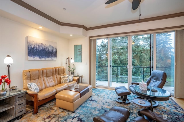 living room featuring wood-type flooring, ceiling fan, and ornamental molding