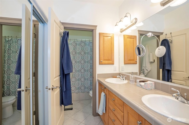 bathroom featuring toilet, tile patterned flooring, and vanity