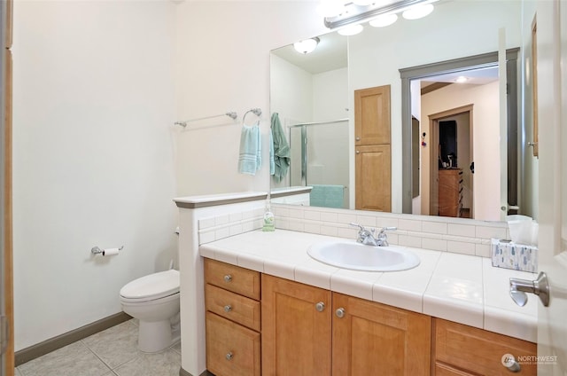 bathroom featuring vanity, an enclosed shower, tile patterned floors, and toilet