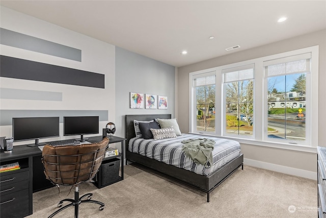 carpeted bedroom featuring multiple windows