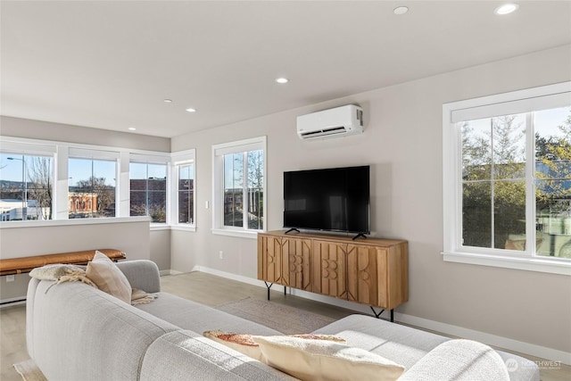 living room featuring a healthy amount of sunlight and a wall mounted AC