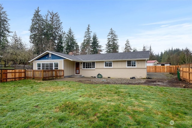 rear view of property featuring a yard