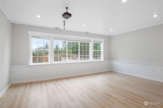 spare room featuring light wood-type flooring