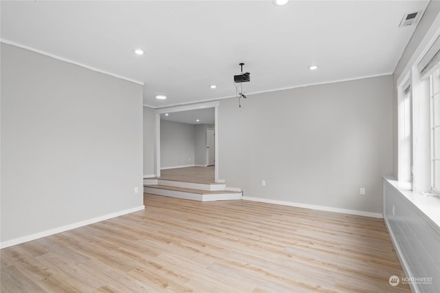 unfurnished room with plenty of natural light, crown molding, and light hardwood / wood-style flooring