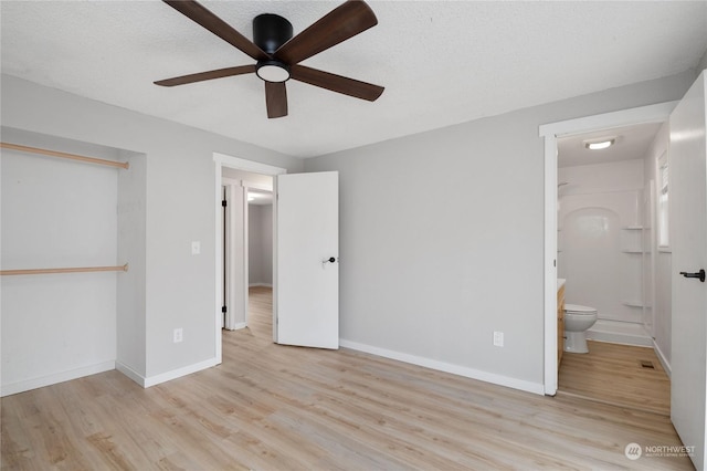 unfurnished bedroom with a textured ceiling, connected bathroom, a closet, ceiling fan, and light hardwood / wood-style flooring