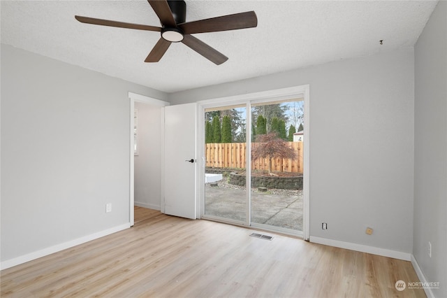 unfurnished room featuring ceiling fan, a textured ceiling, and light wood-type flooring