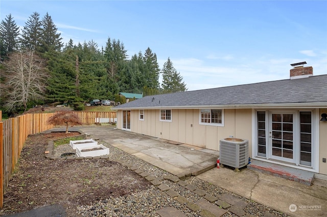 rear view of property with central air condition unit and a patio