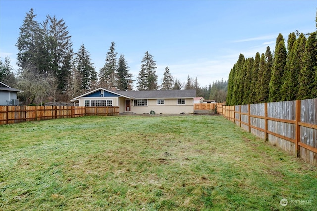 rear view of house with a yard