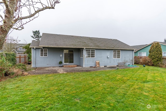 rear view of house with a lawn