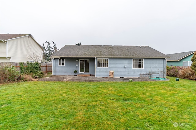 rear view of house with a yard