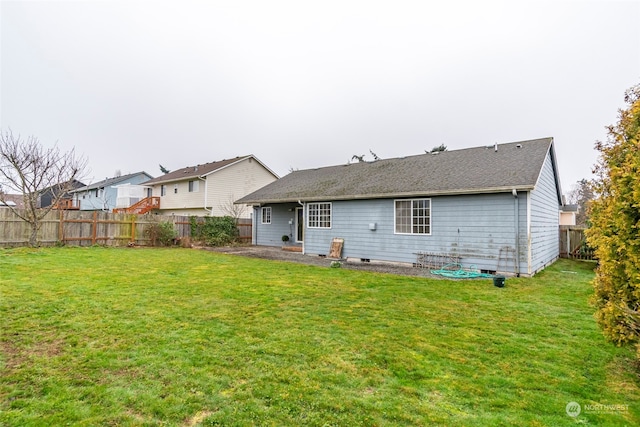 back of house featuring a yard