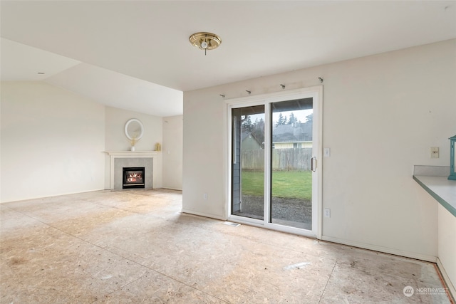 unfurnished living room with vaulted ceiling