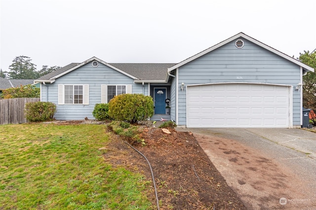 ranch-style home with a front lawn and a garage