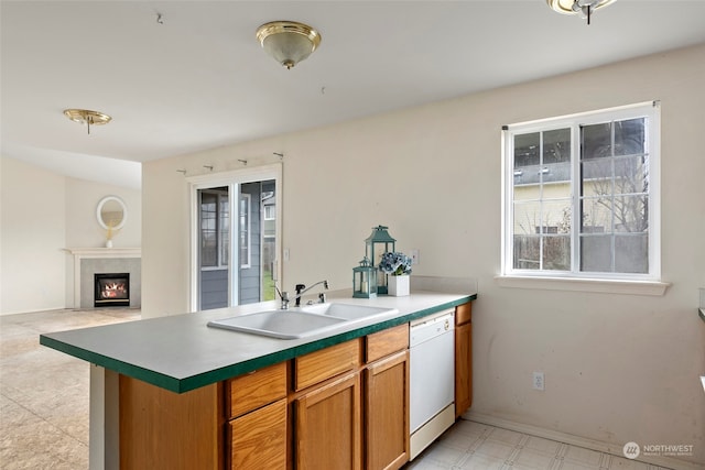 kitchen featuring sink, dishwasher, and kitchen peninsula