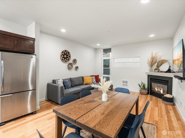 dining area with light hardwood / wood-style floors