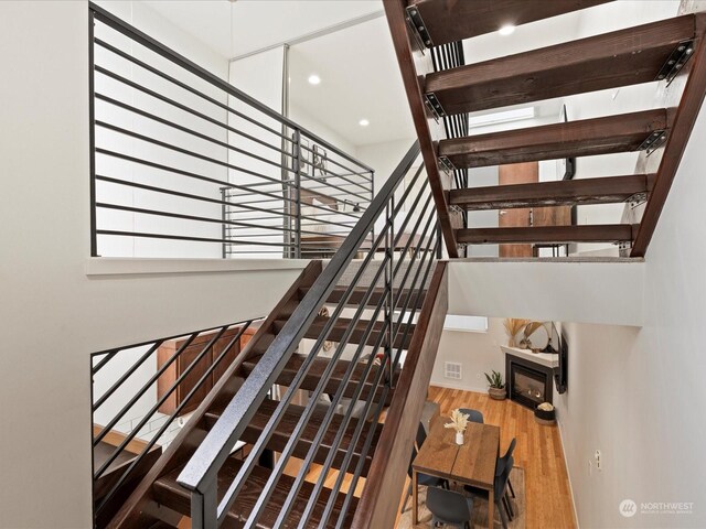 staircase with wood-type flooring