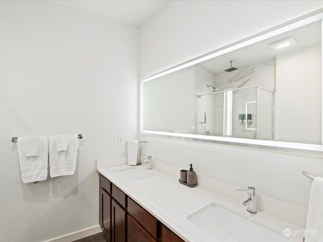 bathroom featuring an enclosed shower and vanity