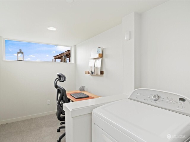 laundry room featuring washer / dryer and light carpet