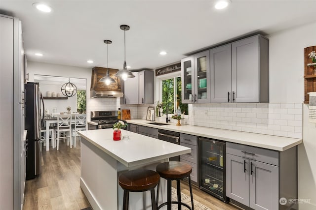 kitchen with sink, gray cabinetry, wine cooler, and appliances with stainless steel finishes