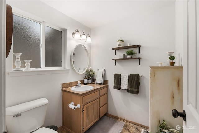 bathroom featuring vanity and toilet