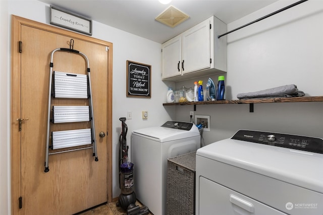 clothes washing area featuring cabinets and washing machine and dryer