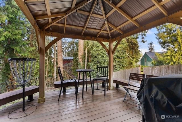 wooden terrace with a gazebo and area for grilling