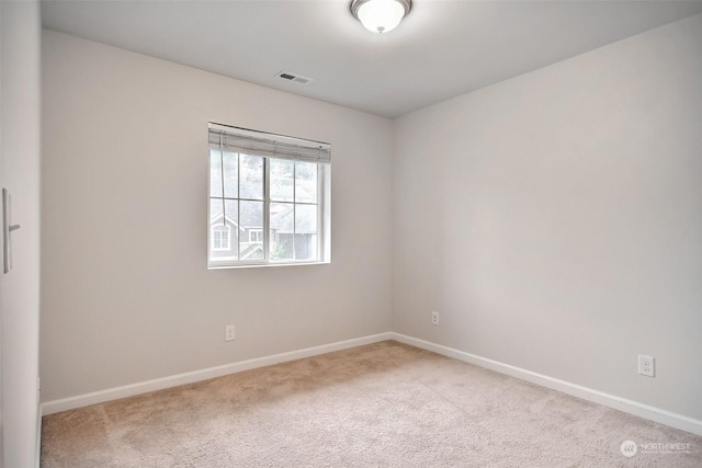 carpeted empty room with baseboards and visible vents