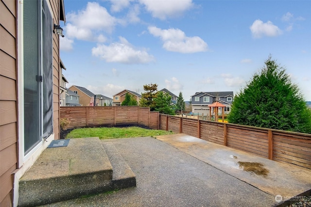 view of patio / terrace featuring a residential view and a fenced backyard