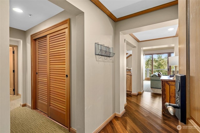 hall featuring dark hardwood / wood-style floors and ornamental molding