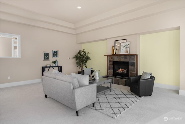 living room with light colored carpet and a fireplace