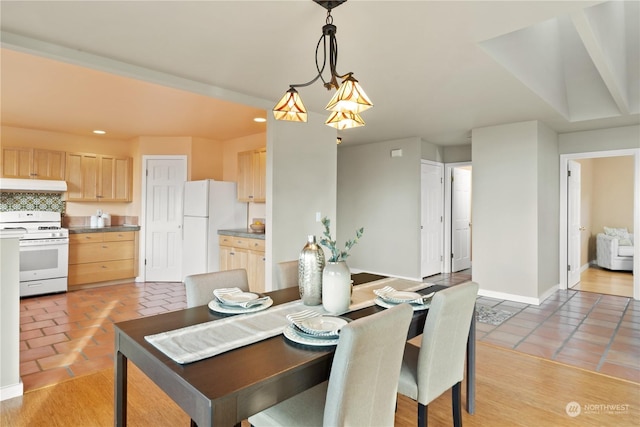 tiled dining space with a notable chandelier