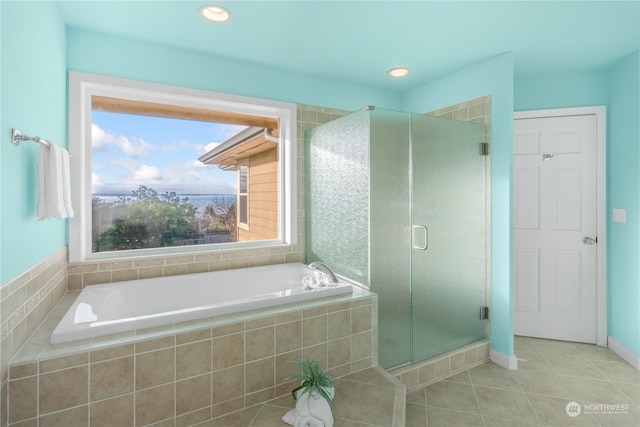 bathroom with tile patterned flooring and independent shower and bath