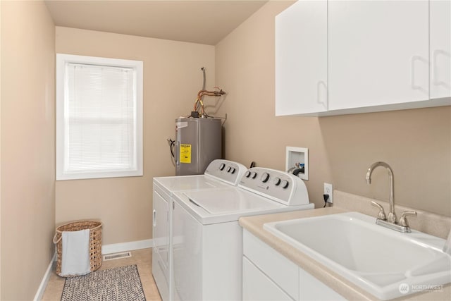 laundry area featuring electric water heater, independent washer and dryer, sink, light tile patterned floors, and cabinets