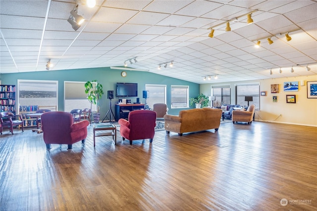 living room featuring hardwood / wood-style flooring and vaulted ceiling