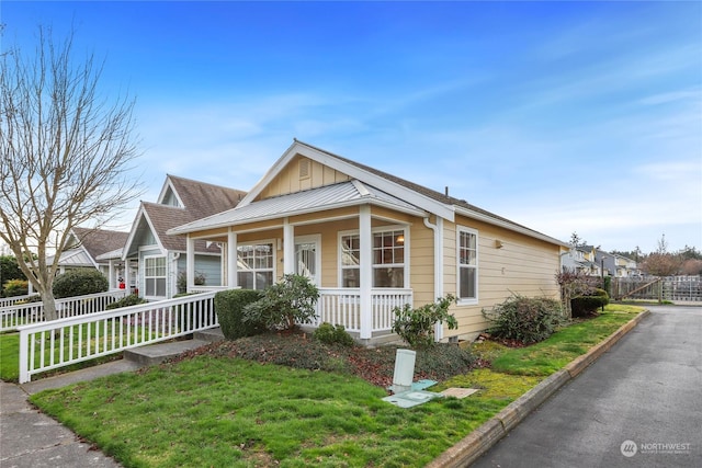 view of front of home featuring a front yard and a porch