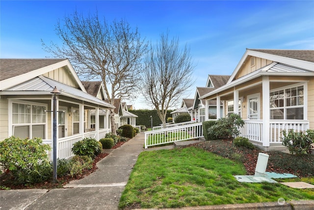 view of home's exterior featuring covered porch and a yard